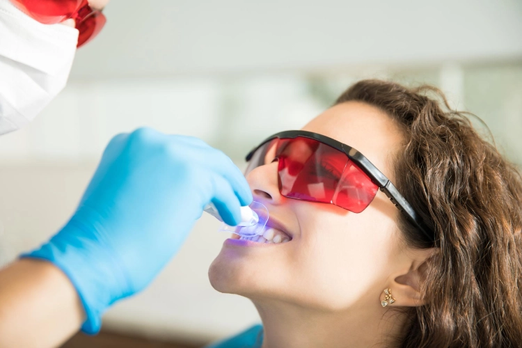 Dentist performing laser gum treatment in Surrey