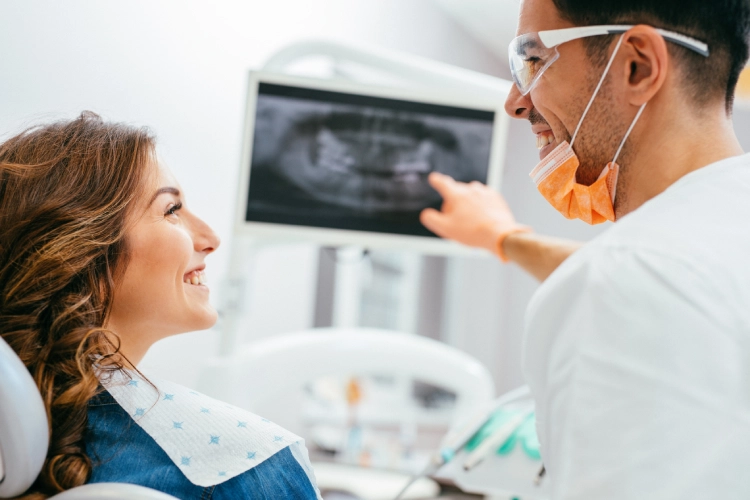 Dentist reviewing x-ray results with patient